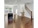 Open-concept space with hardwood floors, a staircase, and a kitchen island at 1813 Hislop Ln, Atlanta, GA 30345