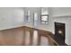 View of bright living room with fireplace, hardwood floors, and walk-out porch at 1813 Hislop Ln, Atlanta, GA 30345
