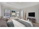 A spacious main bedroom featuring a tray ceiling, large windows, and stylish decor for a relaxing retreat at 1813 Hislop Ln, Atlanta, GA 30345