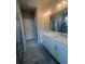 Well-lit bathroom with double sink vanity, tile floors, and glass shower at 277 Lakeside Pl, Canton, GA 30114