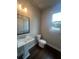 Bathroom featuring pedestal sink, large mirror, white tile and modern fixture at 277 Lakeside Pl, Canton, GA 30114