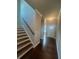 Welcoming entryway showcasing the staircase and wood floors leading to a bright, white front door at 277 Lakeside Pl, Canton, GA 30114