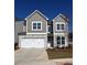 Charming two-story home featuring stone accents, gray siding and a two-car white garage door at 277 Lakeside Pl, Canton, GA 30114
