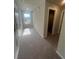 Upstairs hallway featuring multiple rooms, neutral carpet, and a bright window at 277 Lakeside Pl, Canton, GA 30114