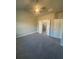 Spacious main bedroom with carpet, ceiling fan, and ensuite bathroom access at 277 Lakeside Pl, Canton, GA 30114