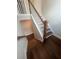Beautiful staircase with wood steps, white risers, and stained wood banister at 277 Lakeside Pl, Canton, GA 30114
