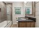 Bathroom with tiled shower and a rustic vanity with granite countertop at 3733 Doroco Dr, Atlanta, GA 30340