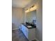 Bathroom with granite vanity with double sinks, tile floor, and vanity lighting at 90 Hammock Dr, Covington, GA 30016