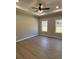 Bedroom with tray ceilings, wood floors, and natural light at 90 Hammock Dr, Covington, GA 30016