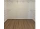 Empty walk-in closet with wire shelving and wood floors at 90 Hammock Dr, Covington, GA 30016
