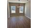 Dining room area with hardwood floors, natural light, and neutral paint at 90 Hammock Dr, Covington, GA 30016