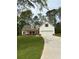 Charming home featuring a manicured lawn, a two car garage and decorative window shutters at 90 Hammock Dr, Covington, GA 30016