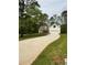 Charming home with a lush green lawn and a long driveway leading to the two-car garage at 90 Hammock Dr, Covington, GA 30016