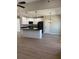 Kitchen area with white cabinets, an island, black appliances, and wood floors at 90 Hammock Dr, Covington, GA 30016
