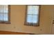 Bright living room with neutral walls and wood floors, featuring natural light through two windows at 430 Poole Bridge Rd, Hiram, GA 30141