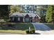 Brick ranch house with landscaped yard and long driveway at 1025 Copper Creek Dr, Canton, GA 30114