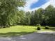 Scenic view of lush green lawn dotted with trees, offering a peaceful outdoor space at 6054 Nebo Rd, Hiram, GA 30141