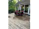 Exterior wooden deck with table and chairs next to a sunroom at 6054 Nebo Rd, Hiram, GA 30141