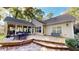 Home exterior featuring a deck, outdoor furniture, and a sunroom surrounded by trees at 6054 Nebo Rd, Hiram, GA 30141