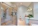 Modern bathroom with a glass-enclosed shower, built-in bench, and separate vanity area at 6054 Nebo Rd, Hiram, GA 30141