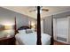Cozy bedroom with a four-poster bed, hardwood floors, and natural light at 6054 Nebo Rd, Hiram, GA 30141