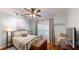 Light-filled bedroom with hardwood floors, ceiling fan, and large window at 6054 Nebo Rd, Hiram, GA 30141