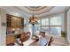 Charming breakfast nook features built-in cabinets, a decorative chandelier and sun-drenched windows overlooking the backyard at 6054 Nebo Rd, Hiram, GA 30141