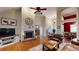 Bright living room boasts hardwood floors, a stone fireplace, and an open design with views of the dining area at 6054 Nebo Rd, Hiram, GA 30141