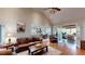 Spacious living room with hardwood floors, vaulted ceilings, and an open layout to the kitchen and sunroom at 6054 Nebo Rd, Hiram, GA 30141