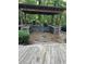 Covered outdoor kitchen featuring stone accents, countertops, and built-in appliances at 6054 Nebo Rd, Hiram, GA 30141