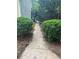 Backyard stone path lined with bushes and mulch leading to the house at 6054 Nebo Rd, Hiram, GA 30141
