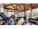 Cozy sunroom with wood floors, wood paneled ceiling, floor-to-ceiling windows and a fireplace at 6054 Nebo Rd, Hiram, GA 30141