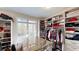Custom walk-in closet with built-in shelving, drawers, and a center island at 6054 Nebo Rd, Hiram, GA 30141