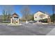 View of the gated community entrance with gate arms, guard house, and attractive landscaping features at 3034 Liberty Nw Way, Atlanta, GA 30318