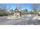 Gated community entrance with guard house, security features, and colorful landscaping at 3034 Liberty Nw Way, Atlanta, GA 30318