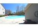 Community pool area featuring clear, blue water and concrete deck, with a building in the background at 3034 Liberty Nw Way, Atlanta, GA 30318