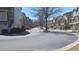 View of a street lined with charming townhomes and landscaped yards, creating an inviting neighborhood feel at 3034 Liberty Nw Way, Atlanta, GA 30318