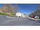 Street view featuring well-maintained townhomes, mature trees, and ample parking for residents and guests at 3034 Liberty Nw Way, Atlanta, GA 30318