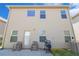 Backyard exterior featuring patio chairs, a grill, and an air conditioning unit at 11948 Brightside Pkwy, Hampton, GA 30228