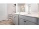Bathroom vanity featuring double sinks, cabinets, white countertop, and view of the shower at 11948 Brightside Pkwy, Hampton, GA 30228