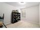 Carpeted bedroom featuring a bookshelf, window and overhead lighting at 11948 Brightside Pkwy, Hampton, GA 30228