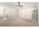 Large bedroom features neutral carpet, vaulted ceiling with ceiling fan, and two doorways at 11948 Brightside Pkwy, Hampton, GA 30228