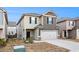 Two-story home featuring neutral siding, gray garage door, and dark trim at 11948 Brightside Pkwy, Hampton, GA 30228