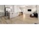 Spacious open floor plan combining the kitchen and living area with light-colored floors and neutral paint at 11948 Brightside Pkwy, Hampton, GA 30228
