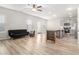 Open living space with light wood floors, neutral walls, and a view into the kitchen at 11948 Brightside Pkwy, Hampton, GA 30228