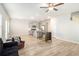 Open living space with light wood floors, neutral walls, and a view into the kitchen at 11948 Brightside Pkwy, Hampton, GA 30228
