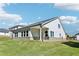 Home's backyard featuring a grassy lawn, dark roof, and neutral-colored siding at 1638 High Falls Ln, Grayson, GA 30017