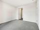 Inviting bedroom featuring neutral walls, gray carpet, and an entry door at 1638 High Falls Ln, Grayson, GA 30017