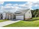 Rear-side view of a charming home with a brick facade, a two-car garage, and lush green landscaping at 1638 High Falls Ln, Grayson, GA 30017