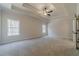 Main bedroom with tray ceiling and access to bathroom at 268 Pinewood Dr, Covington, GA 30014